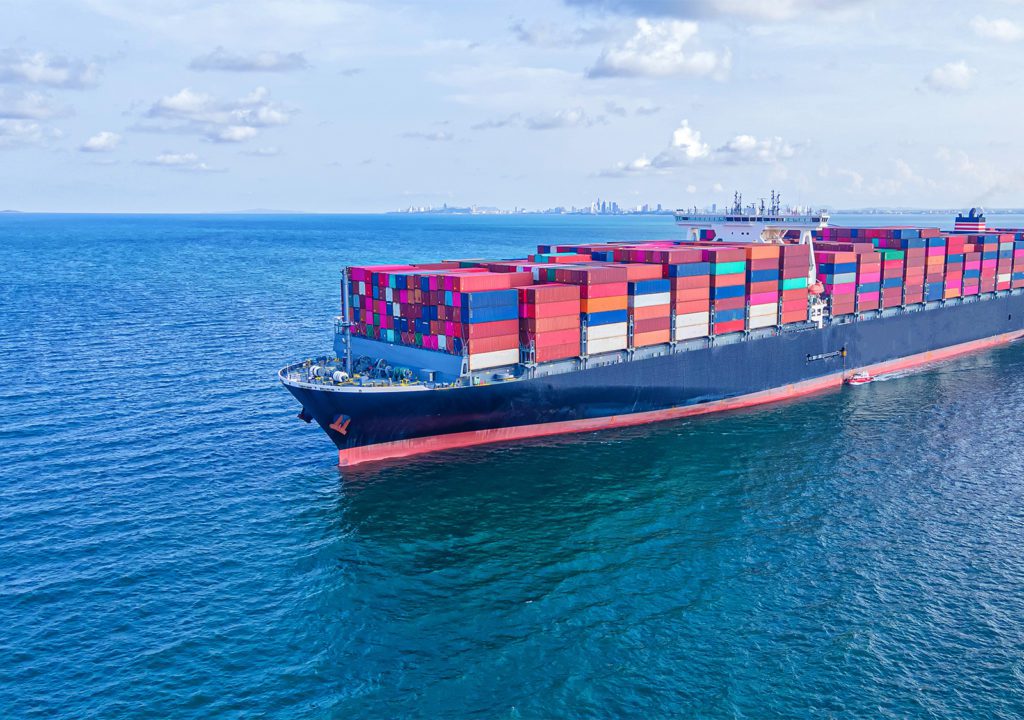 Maritime ship with colorful containers sails on the ocean